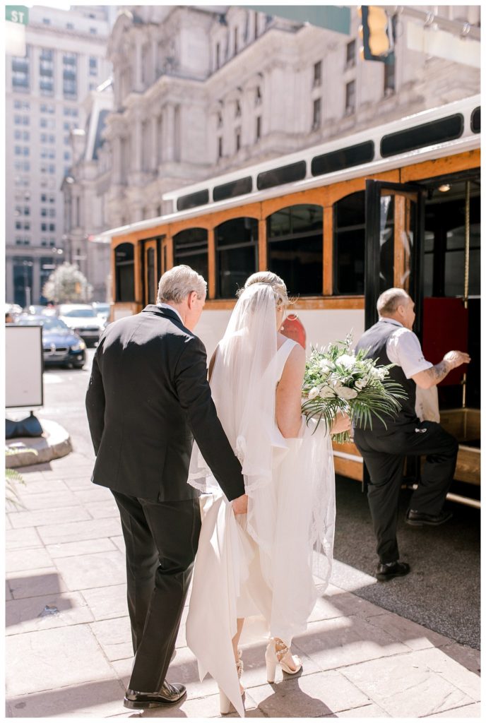 "Bride getting into trolley with dad"